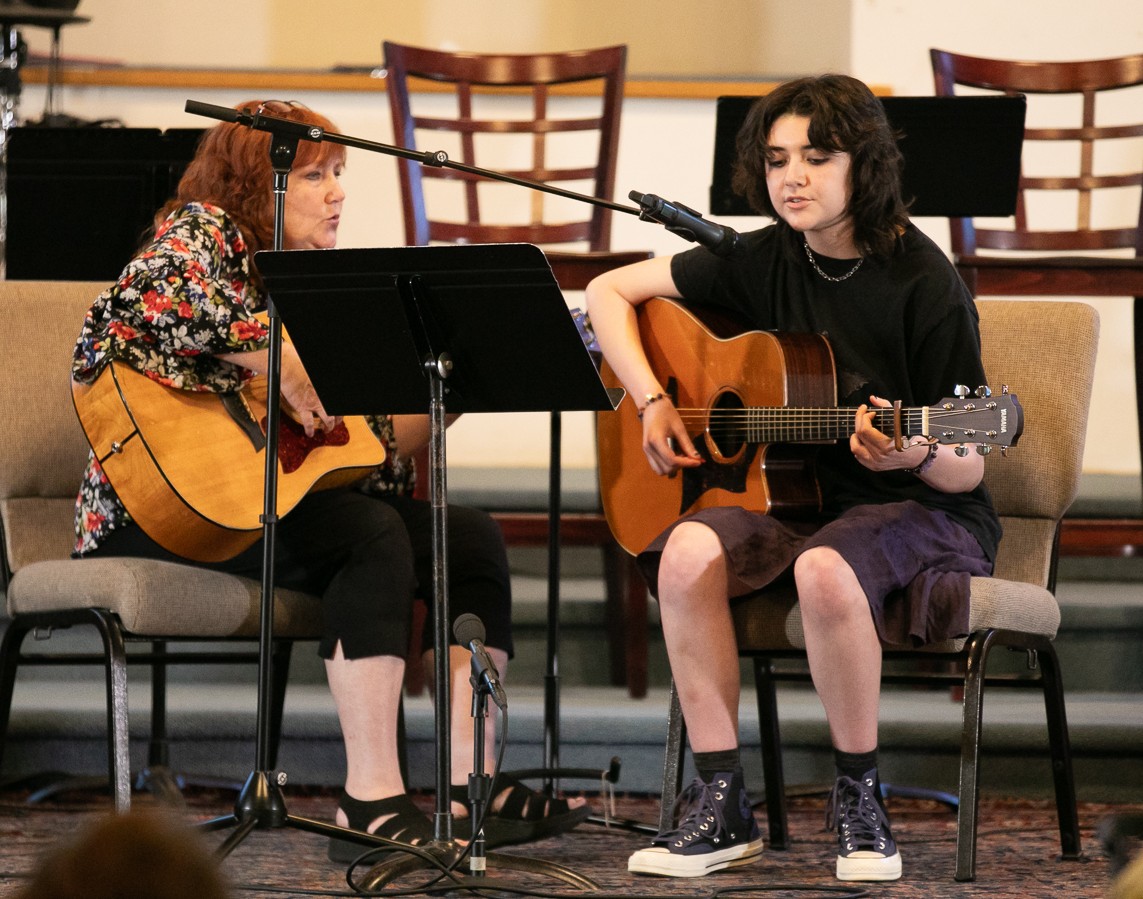 Student performing guitar as part of studio progress and performances